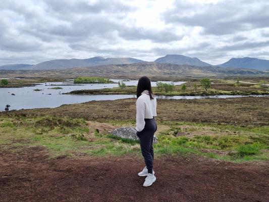 Girl looking at mountains; eco friendly travel tips