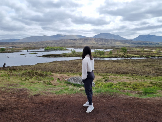 Girl looking at mountains; eco friendly travel tips