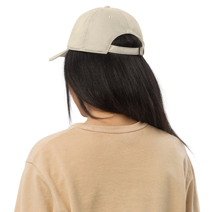 Organic embroidered hat back view, travel outfit ideas accessory